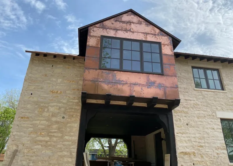 Copper metal panel facade on a stone building for Skylight Installation in Crystal Lake