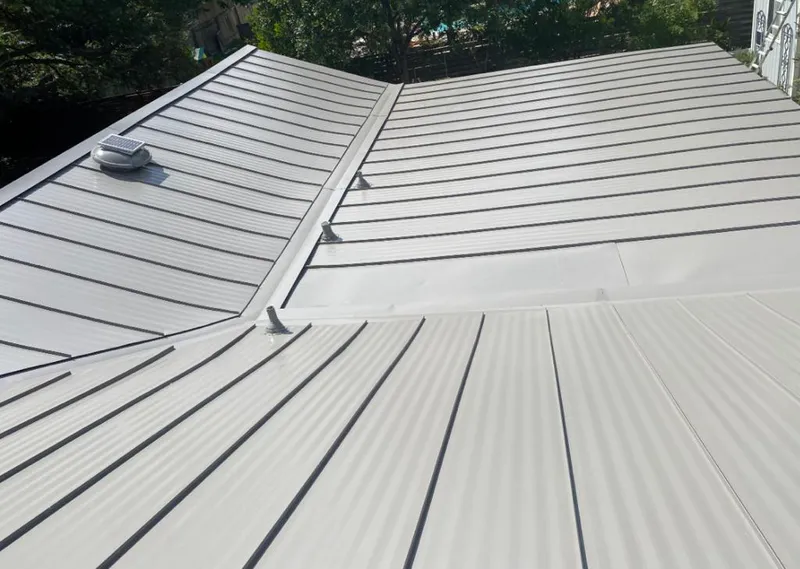 Solar attic fan installed on a metal roof for Roof Ventilation in Crystal Lake