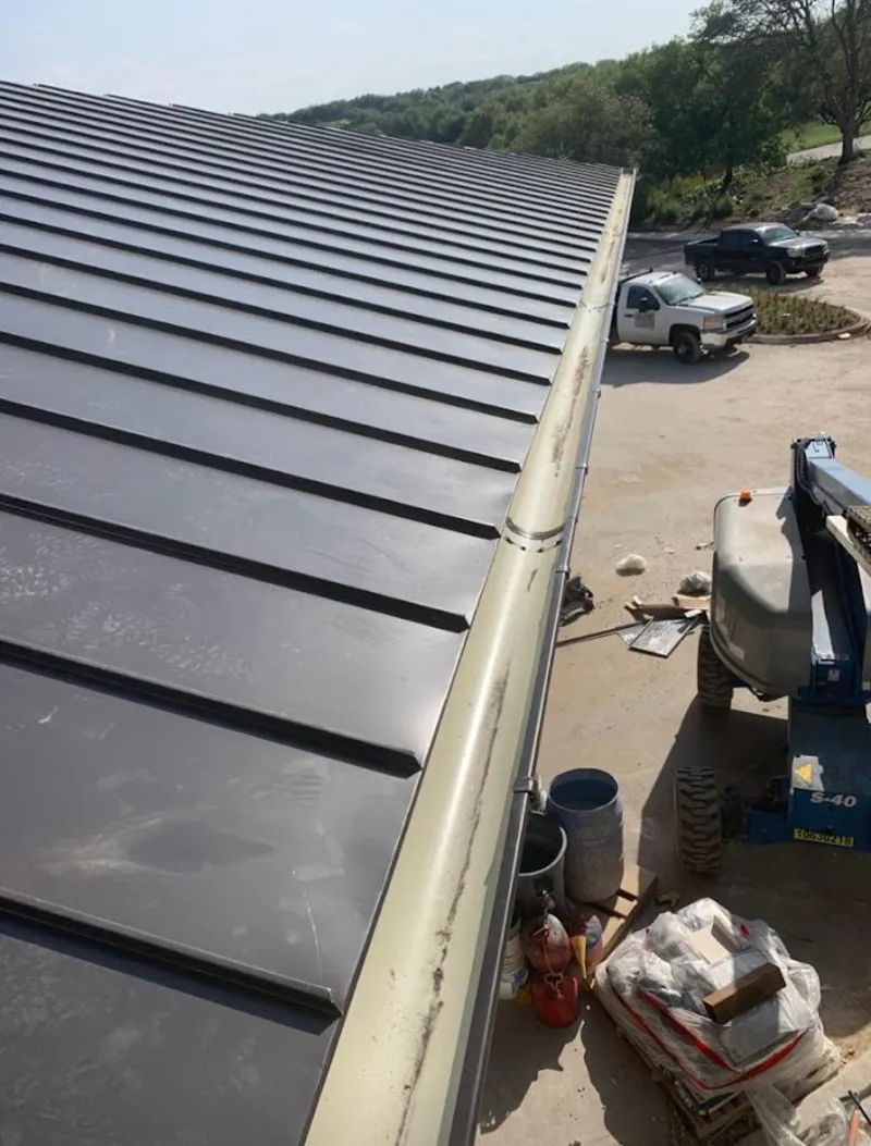 Standing seam panel and gutter detail on a metal roofing jobsite in Crystal Lake